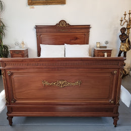 Louis XVI style Mahogany Queen size bed on original castors. This bed has beautiful carved details and and Ormolu mounts in good original detailed condition