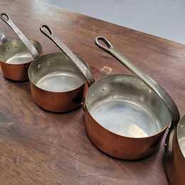 Set of five copper sauce pans with foundry stamp. They have been sourced from France and are in good original detailed condition.