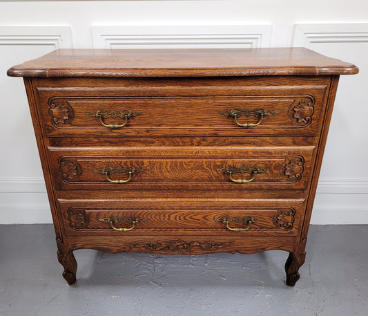 French Louis XV style Oak three drawer chest with wooden top. It has been sourced from France and is in good original detailed condition.
