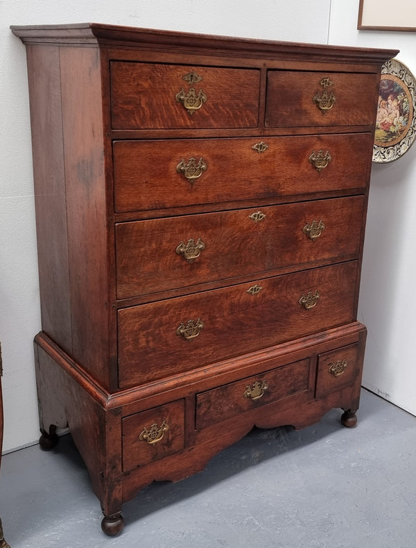 Early 19th Century English Oak chest on stand. It has been sourced in France and has plenty of storage space with eight drawers. In good original detailed condition.