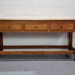 Late 19th Century Cherrywood console table with three drawers. In good used, detailed rustic condition.