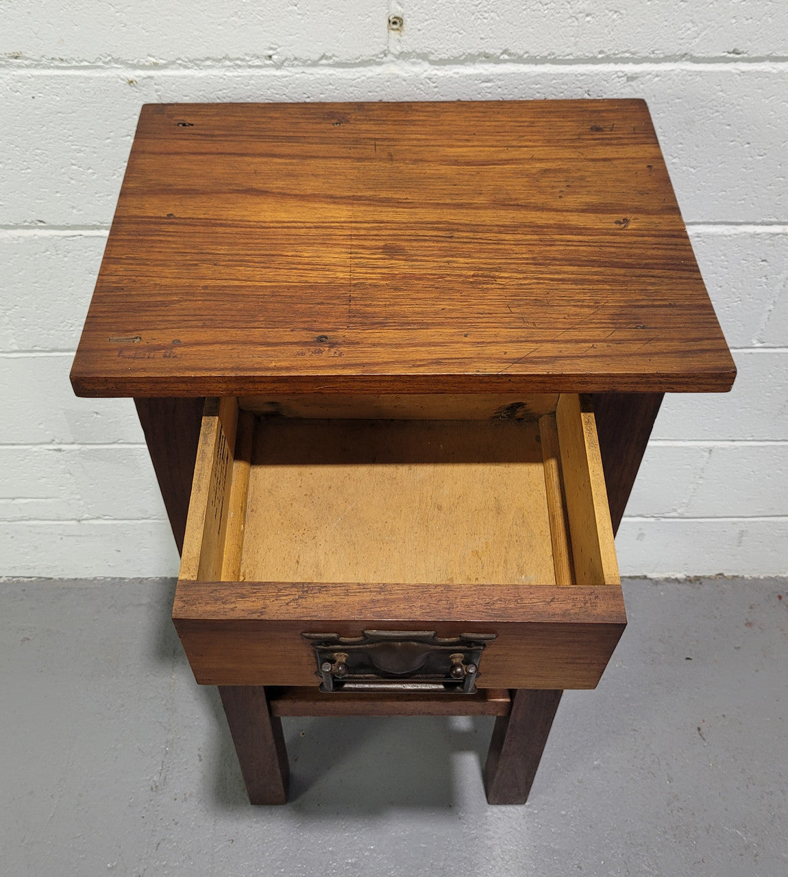 Small Arts and Crafts side table/bedside table. With drawer and is in good original detailed condition.