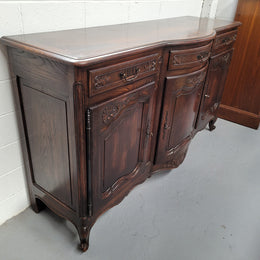 French dark oak three door and three drawer sideboard. Plenty of storage space and it is in good original detailed condition.