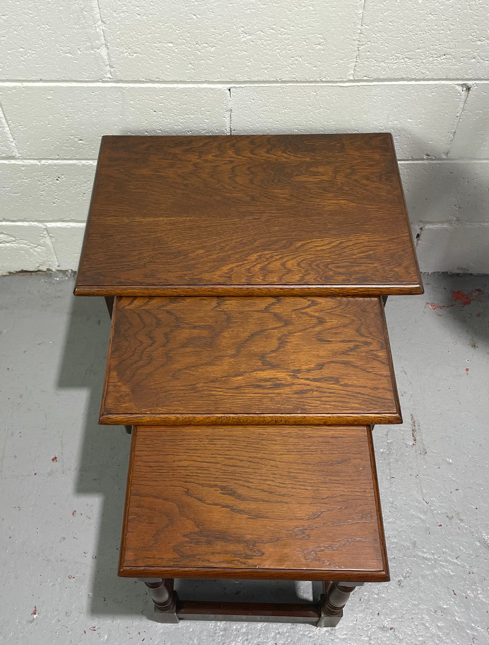 Tudor style English dark Oak nest of three tables. They are in good restored condition.