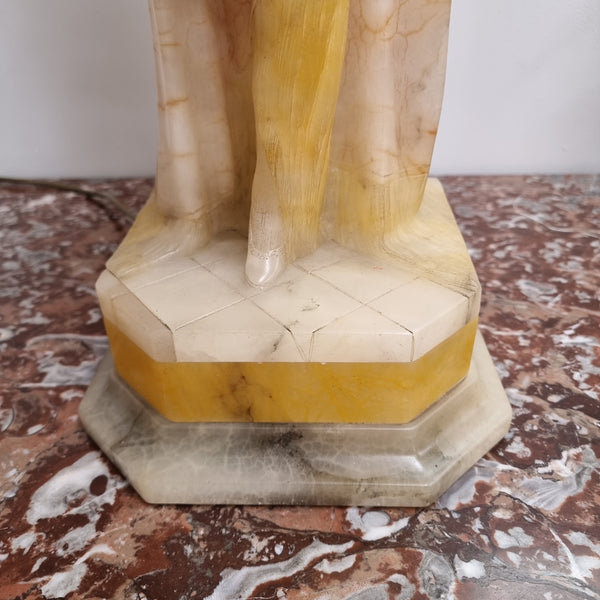 Monumental Art Deco alabaster and marble figural lamp modelled as a seductively dressed semi naked woman. In subtlety coloured diaphanous robes with a large clam shell light backdrop. Italian circa 1920's signed to base. This is a world class example of a true Art Deco sculpture lamp. It is in good original detailed condition, please view photos as they help form part of the description.