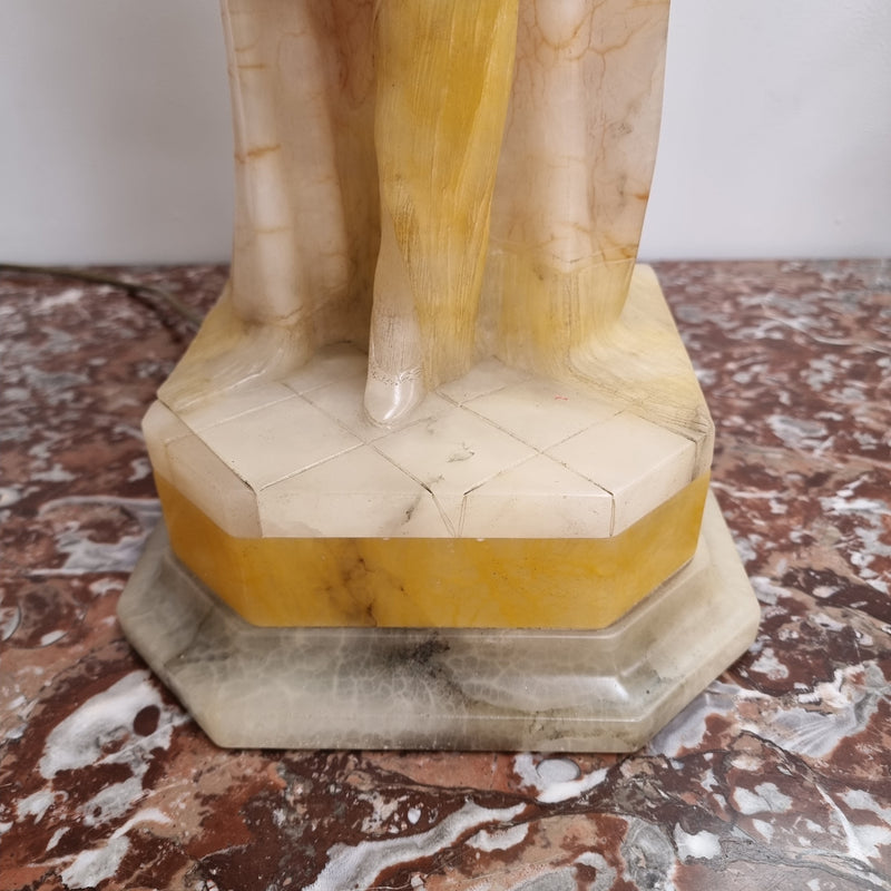 Monumental Art Deco alabaster and marble figural lamp modelled as a seductively dressed semi naked woman. In subtlety coloured diaphanous robes with a large clam shell light backdrop. Italian circa 1920's signed to base. This is a world class example of a true Art Deco sculpture lamp. It is in good original detailed condition, please view photos as they help form part of the description.
