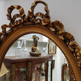 Antique French Gilt Oval Shape Mirror With Ribbon Crest