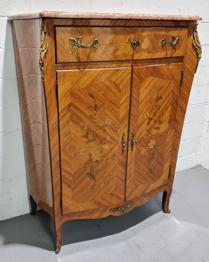 French Louis XV style marquetry inlaid marble top side cabinet. It has one drawer at the top and two doors open up to two adjustable shelves. It has beautiful coloured marble and decorative mounts. In good original detailed condition.