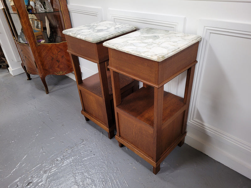 Pair of Antique French Oak Louis XVI style marble top bedside cabinets. They have decorative inlay and have been sourced from France. They are in good original detailed condition.