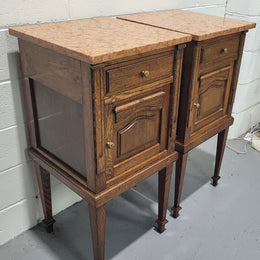 Beautiful pair of French oak bedside cabinets with marble tops. They have a drawer and cupboard for storage and are in good original detailed condition.