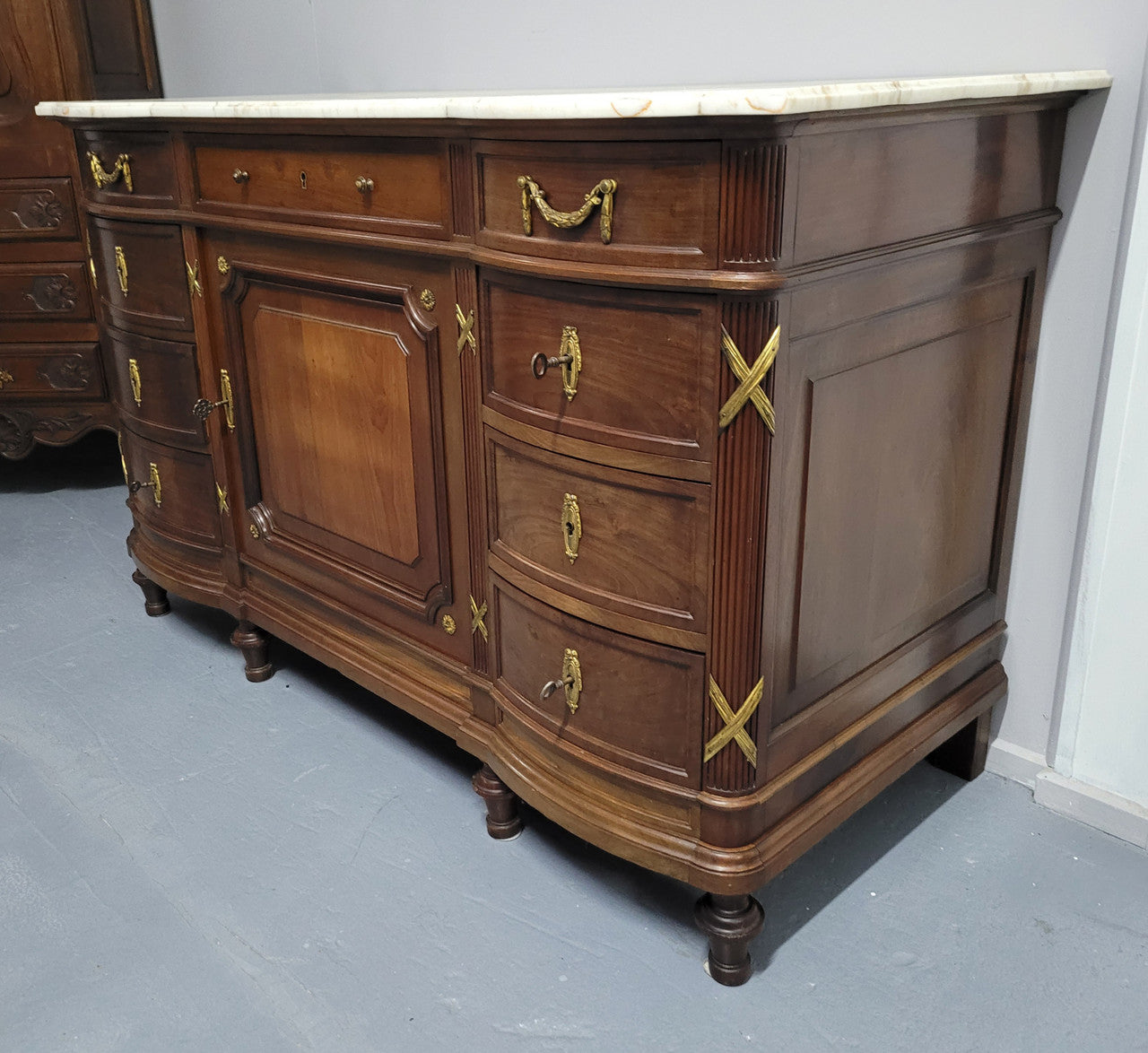 Fabulous French Walnut Louis XVI style cupboard, with a lovely marble top and nine drawers. There is also a cupboard and beautiful ormolu mounts. It is in good original detailed condition.