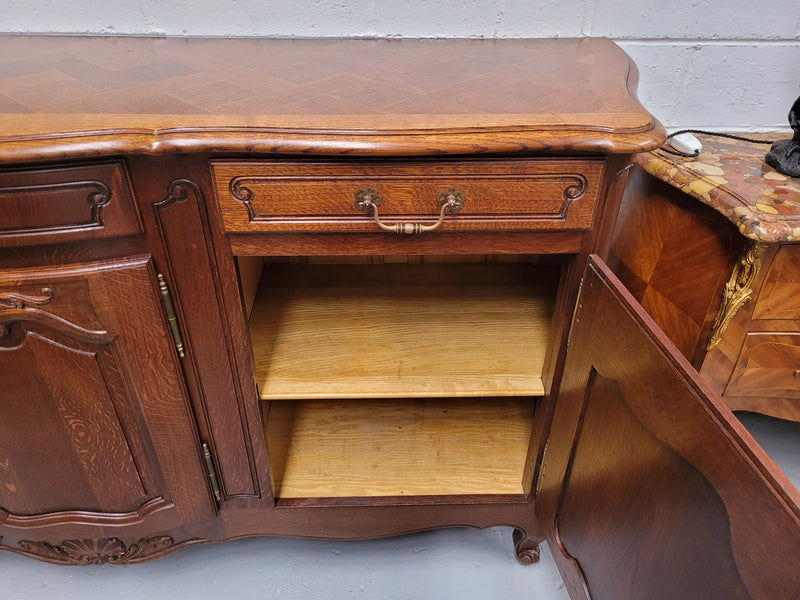 French Oak Louis XV style three drawer three door parquetry top sideboard. It has been sourced from France and is in good original detailed condition.