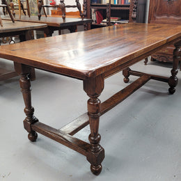 Rustic French Oak stretcher based farmhouse dining table that comfortably seats 6-8 people. It has been sourced from France and is in good original condition.