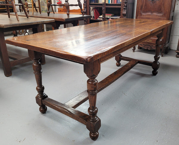 Rustic French Oak stretcher based farmhouse dining table that comfortably seats 6-8 people. It has been sourced from France and is in good original condition.