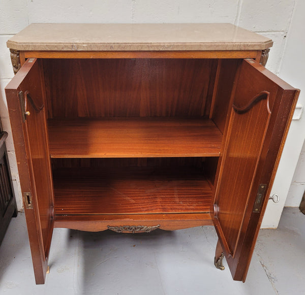 Stunning compact Louis 15th style two door walnut cabinet with ormolu trim and marble top. It is in good original condition.