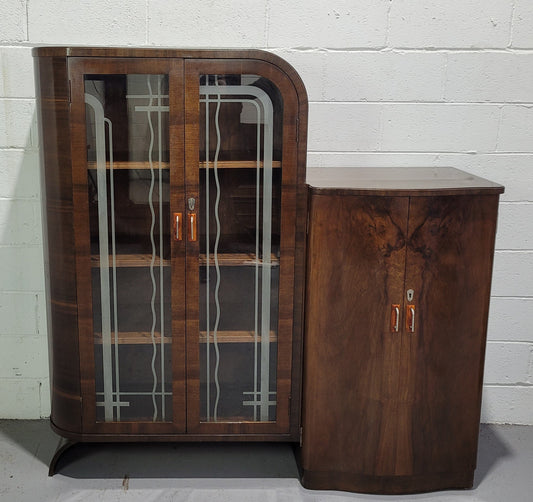 Art Deco Walnut display / drinks cabinet consisting of two glass door display and two door cupboard. Top section also lifts up and turns into a drinks area. All with original handles and in good original detailed condition.