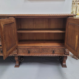 Large French Oak Renaissance style four door sideboard/buffet. Great decorative item with amazing carvings and stunning iron work on base. It is in good original detailed condition. Can pull apart completely making it easier to move.