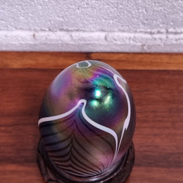Iridescent glass egg shaped paper weight, on small wooden chinese stand. In good original condition. Please see photos as they form part of the description.