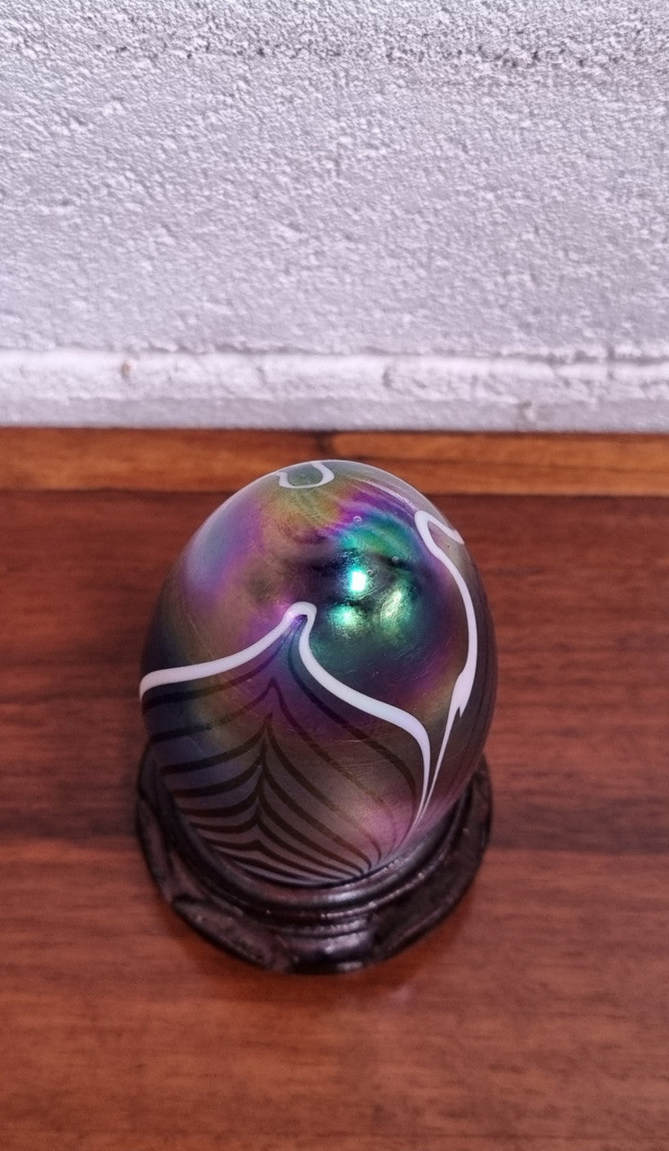 Iridescent glass egg shaped paper weight, on small wooden chinese stand. In good original condition. Please see photos as they form part of the description.