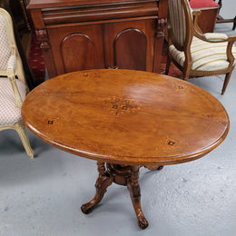 Victorian Walnut oval beautifully inlaid occasional table with bird cage undercarriage. It is in good original detailed condition and it has been sourced locally.