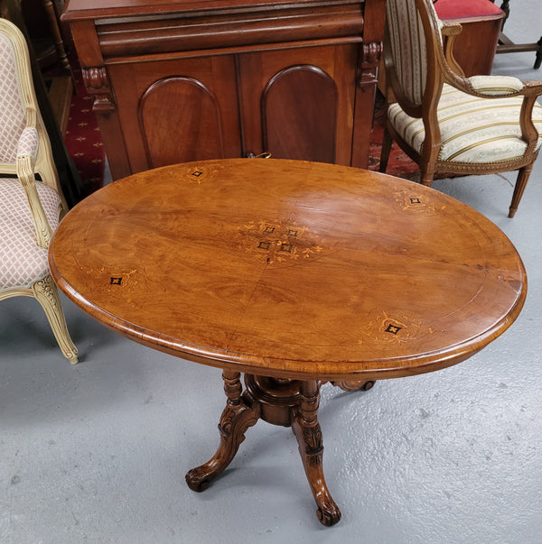 Victorian Walnut oval beautifully inlaid occasional table with bird cage undercarriage. It is in good original detailed condition and it has been sourced locally.