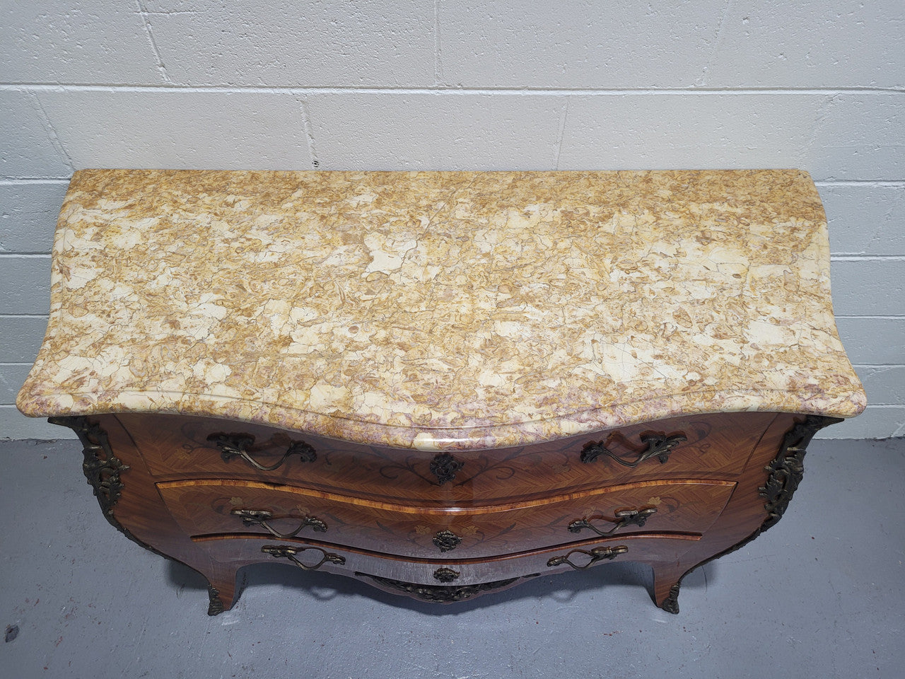 French three drawer marquetry inlaid marble top commode with decorative ormolu mounts. In good original detailed condition.