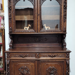 Grand French Oak Gothic style buffet with amazing detailed carvings. This stunning buffet has a display section at the top with two adjustable shelves, two drawers in the middle with elegantly carved handles and storage below with one fixed shelf. It is in good original detailed condition.