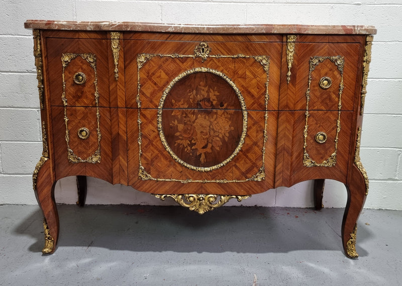 Stunning Louis XV style ormolu and marquetry marble top commode with two drawers. It has an amazing thick marble top and it is in good original detailed condition.