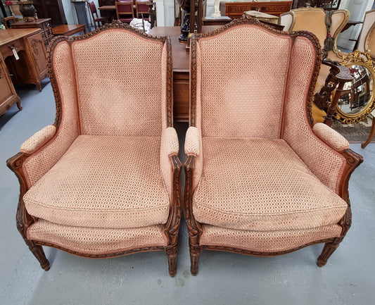 Lovely pair of  French Louis XVI style Walnut, upholstered Bergere chairs with beautiful carving and are in good original detailed condition.