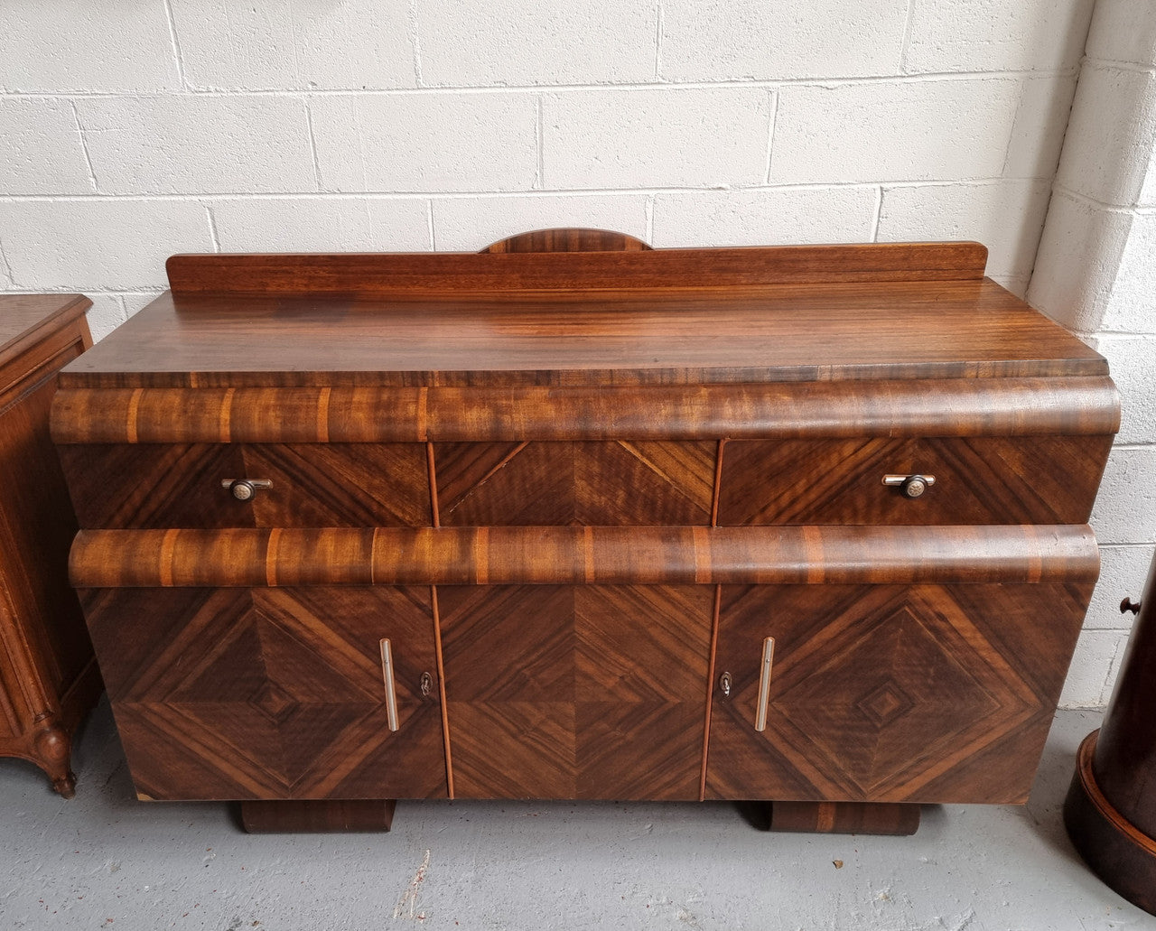 Vintage Walnut Art Deco “Waterfall” sideboard buffet with two drawers and two doors. It is in good original condition and has been sourced locally.