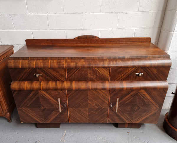 Vintage Walnut Art Deco “Waterfall” sideboard buffet with two drawers and two doors. It is in good original condition and has been sourced locally.