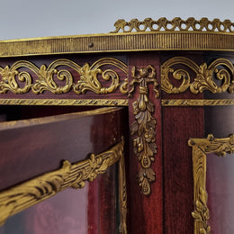 Louis XV style Walnut vitrine display cabinet with attractive ormolu mounts. Beautiful Maroon floral fabric backing with two glass shelves and cabriole legs with decorative ormolu mounts. In good original detailed condition.