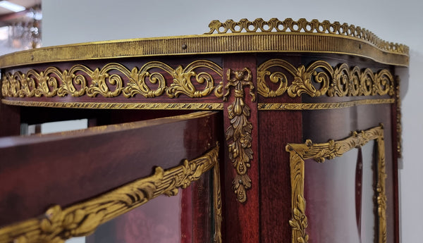 Louis XV style Walnut vitrine display cabinet with attractive ormolu mounts. Beautiful Maroon floral fabric backing with two glass shelves and cabriole legs with decorative ormolu mounts. In good original detailed condition.