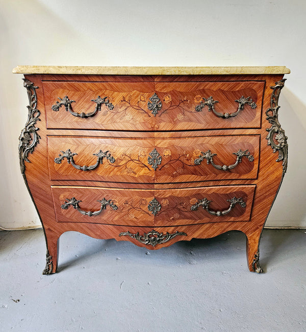 Stunning French Louis 15th style marble topped three drawer commode with marquetry inlay and stunning ormolu mounts. In good original detailed condition.
