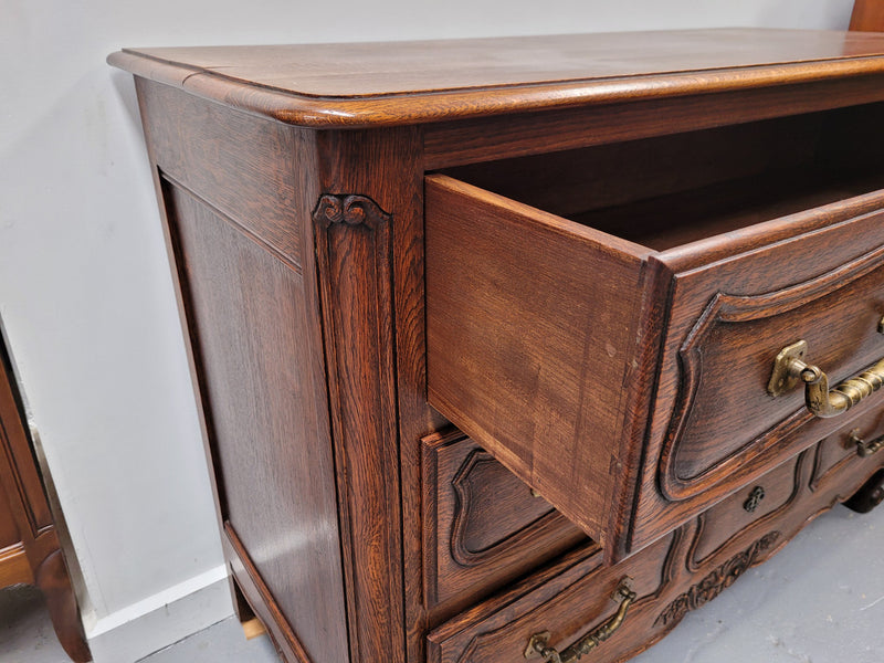 French Provincial Oak three drawer wooden top commode. It has elegant carvings and handles. It has been sourced from France and is in good original detailed condition.