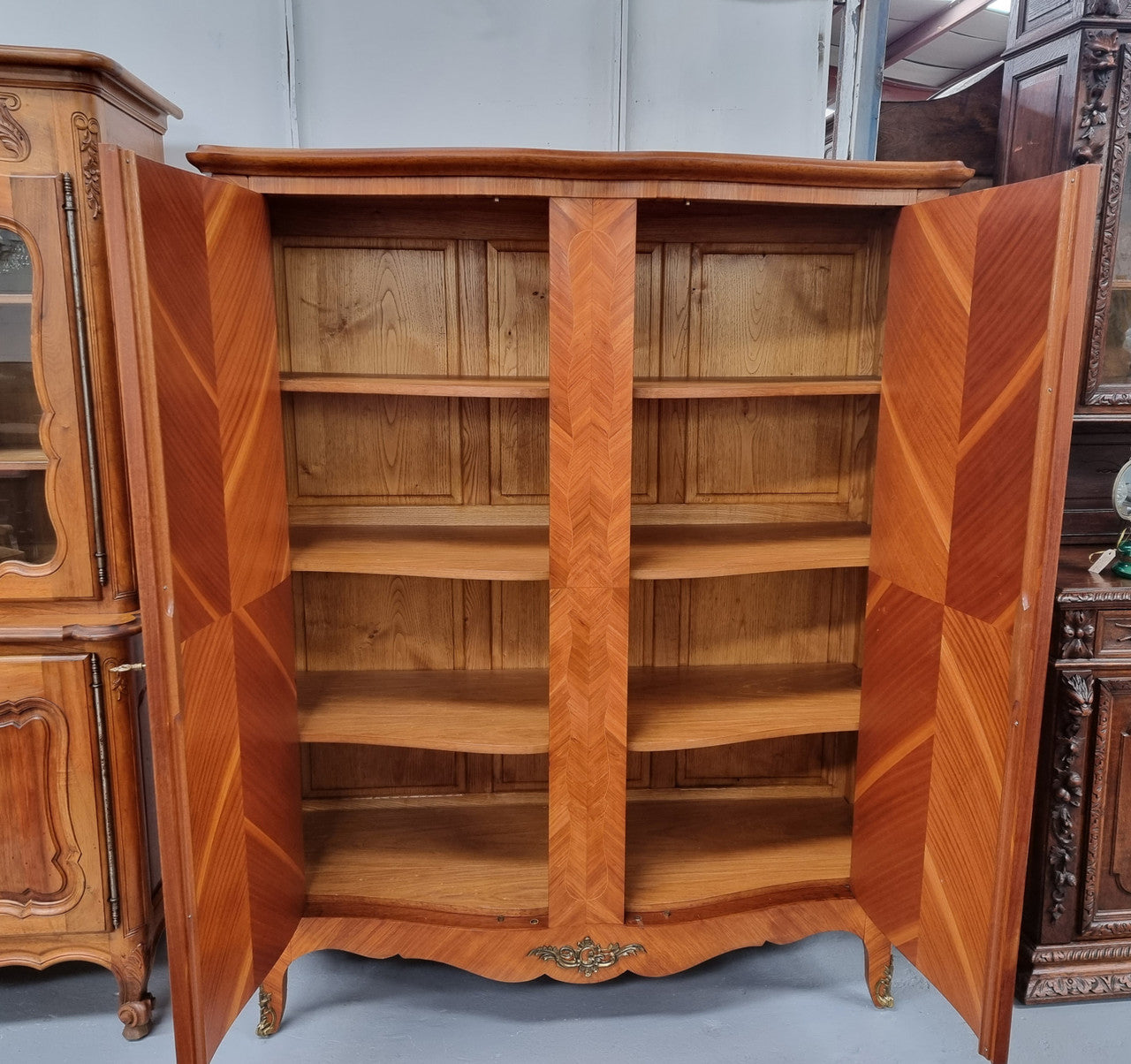 Charming French Louis XV Style Marquetry Inlaid Two Door Armoire. Features three adjustable shelves and ormolu trim. It has been sourced from France and is in good original condition.