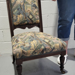 Single upholstered Edwardian nursing chair. Fabric is in good original used condition and chair has four caster wheels and is in good original condition.