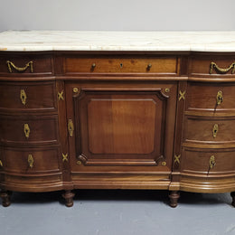 Fabulous French Walnut Louis XVI style cupboard, with a lovely marble top and nine drawers. There is also a cupboard and beautiful ormolu mounts. It is in good original detailed condition.