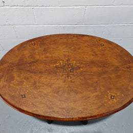 Victorian Walnut oval beautifully inlaid occasional table with bird cage undercarriage. It is in good original detailed condition and it has been sourced locally.