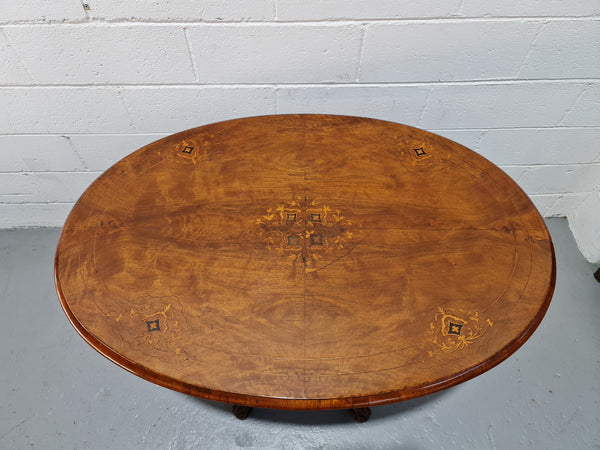 Victorian Walnut oval beautifully inlaid occasional table with bird cage undercarriage. It is in good original detailed condition and it has been sourced locally.