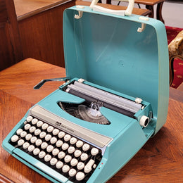 1960's Smith Corona Corsair deluxe portable typewriter. It is in working condition with a used ribbon, and comes with everything pictured. It has been sourced locally.