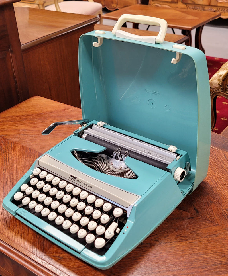 1960's Smith Corona Corsair deluxe portable typewriter. It is in working condition with a used ribbon, and comes with everything pictured. It has been sourced locally.