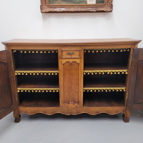 Amazing French Oak early 19th Century two door sideboard with one drawer and two fixed shelves. Sourced from France and in good original detailed condition.