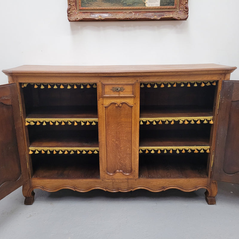 Amazing French Oak early 19th Century two door sideboard with one drawer and two fixed shelves. Sourced from France and in good original detailed condition.