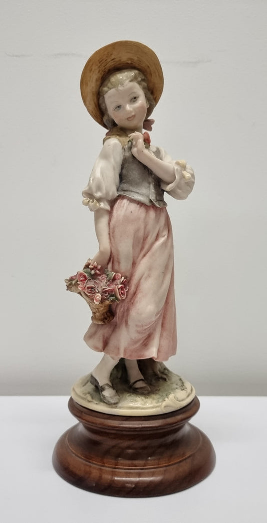 Lovely Italian figurine of girl carrying basket with flowers, figurine is on a wooden base. It is signed Giuseppe Armani and 1982 FLORENCE. In good original condition.  Please view photos as they form part of the description.