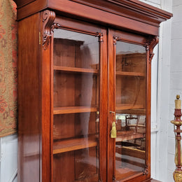 Mid 19th Century Australian Cedar and Flame Cedar tall bookcase. The top has two glass doors that open up to three adjustable shelves followed by a drawer in the middle and finishes with two beautiful wooden doors that open up to a fixed shelf. In good original detailed condition and has been sourced locally.