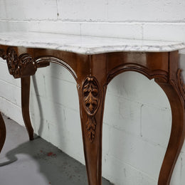An elegant walnut French Louis XV style white marble top console table. It is in good original detailed condition.