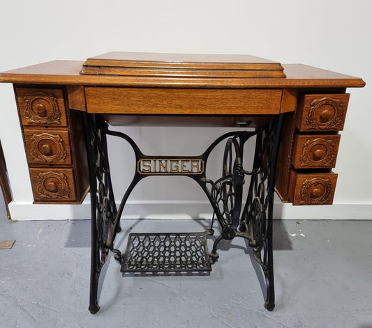 Beautiful Singer sewing machine in an Oak case with six drawers, in mint condition for its age.