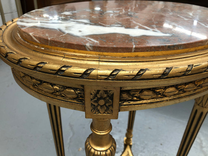 Antique French Louis XVI style gilt, ebonised and marble top side/occasional table. It is Walnut wood that has been gilded over. In good original condition.