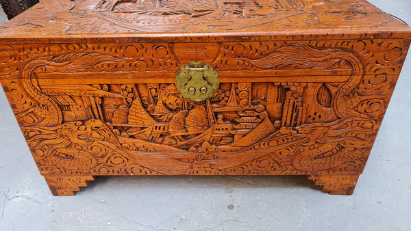 Vintage nicely carved Camphor wood chest. It has amazing carvings of boats, dragons and temples. It is in good original detailed condition.